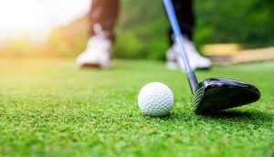 Golfer preparing to hit a golf ball at the Assumption Golf Classic Long Beach